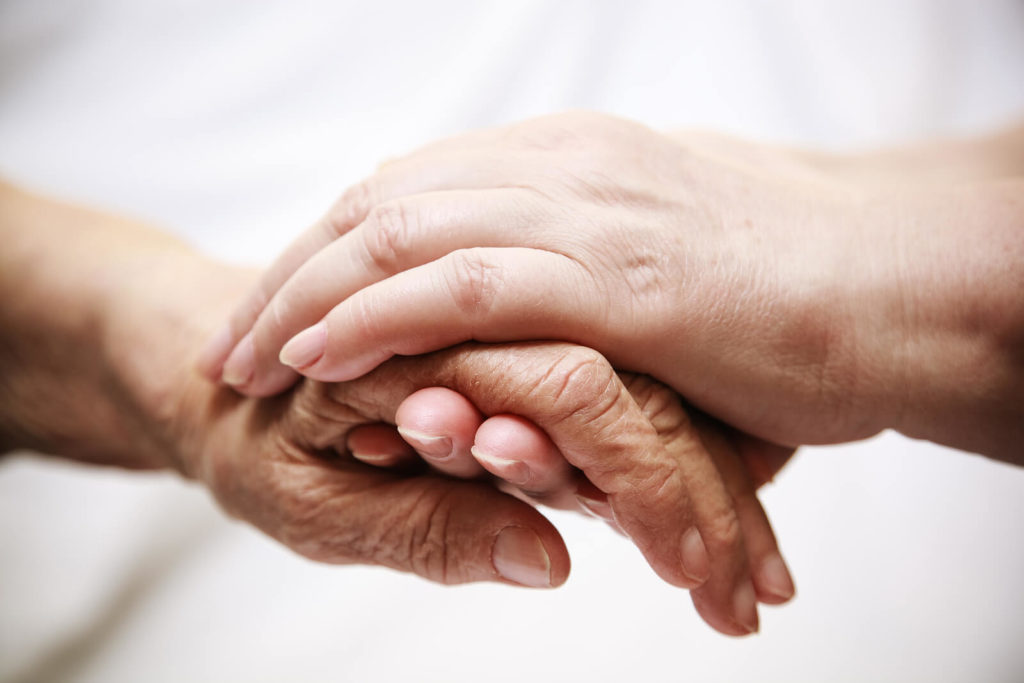 hands held together in long term care